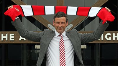 Jack Ross lifts the red and white scarf aloft.